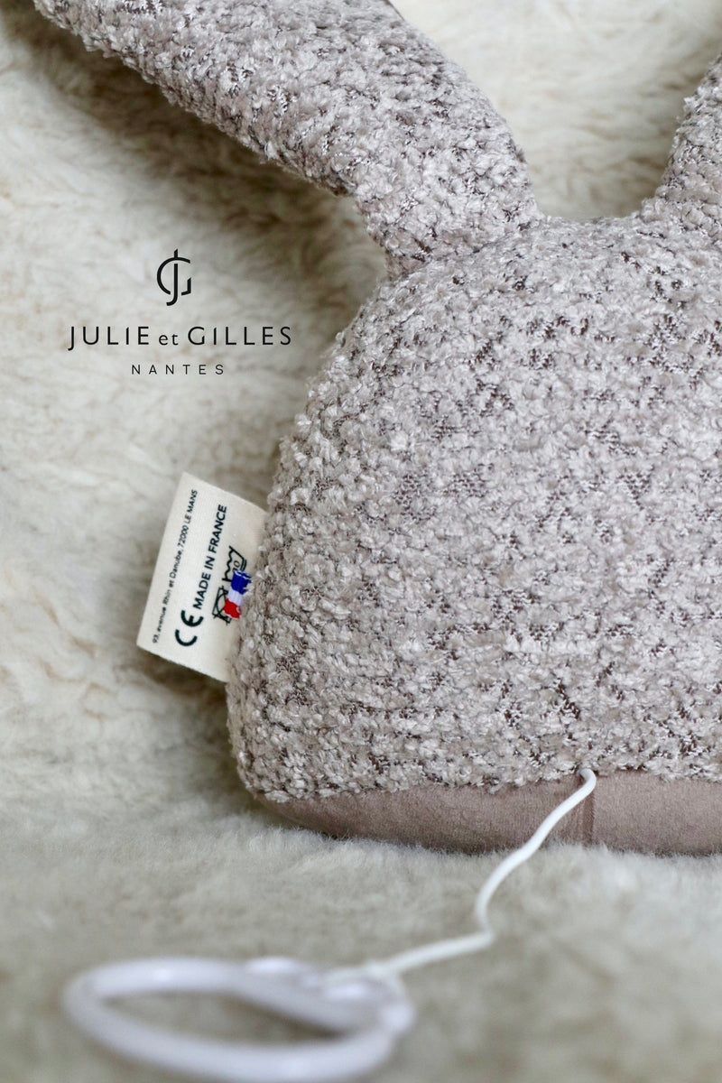 Doudou musical Made in France aux berceuses originales et soporifiques.La collection Doux lapins de Gilles et Julie a été conçue pour endormir bébé en douceur . Ce doudou musical aux longues oreilles pourra aisément s'attacher sur un lit à barreau ou bien même sur un porte manteau . Lignes épurées et style non genré les doux lapins proposent des berceuses plus originales les unes que les que les autres . Coloris beige bouclé.