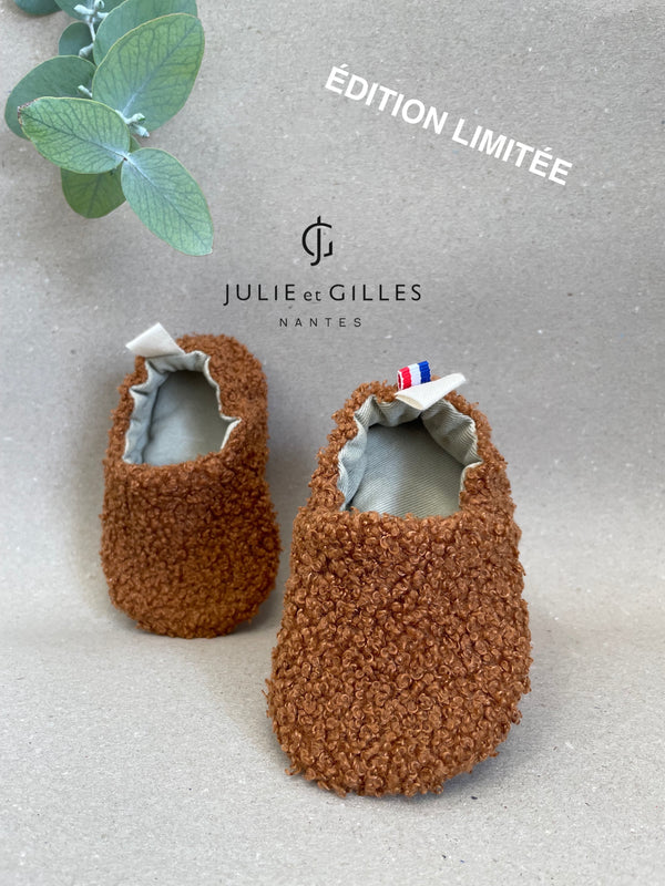 Chaussons bébé Julie et Gilles en tissu sherpa bouclé orangé, doublés en coton 100 % naturel, alliant douceur et confort, fabriqués avec soin en France.